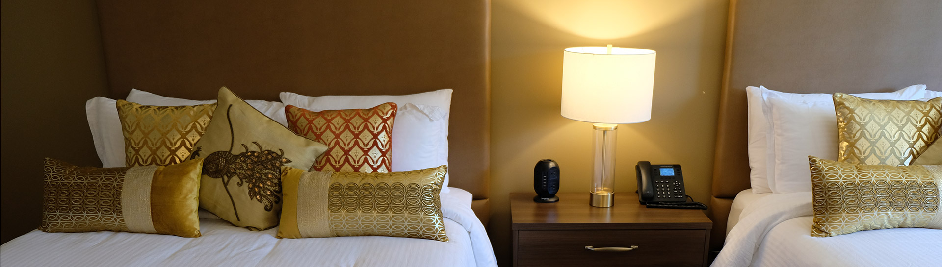 Room at Northumberland Heights retreat with two beds and colourful pillows